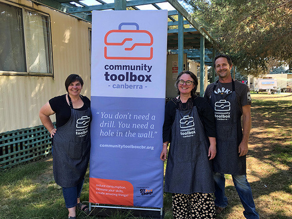 Three community toolbox Canberra members standing and smiling camera